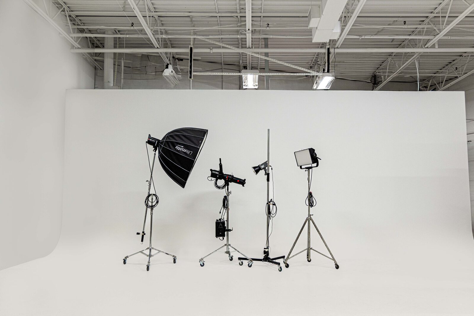 Professional lighting equipment on the cyclorama wall at The Studio Co.